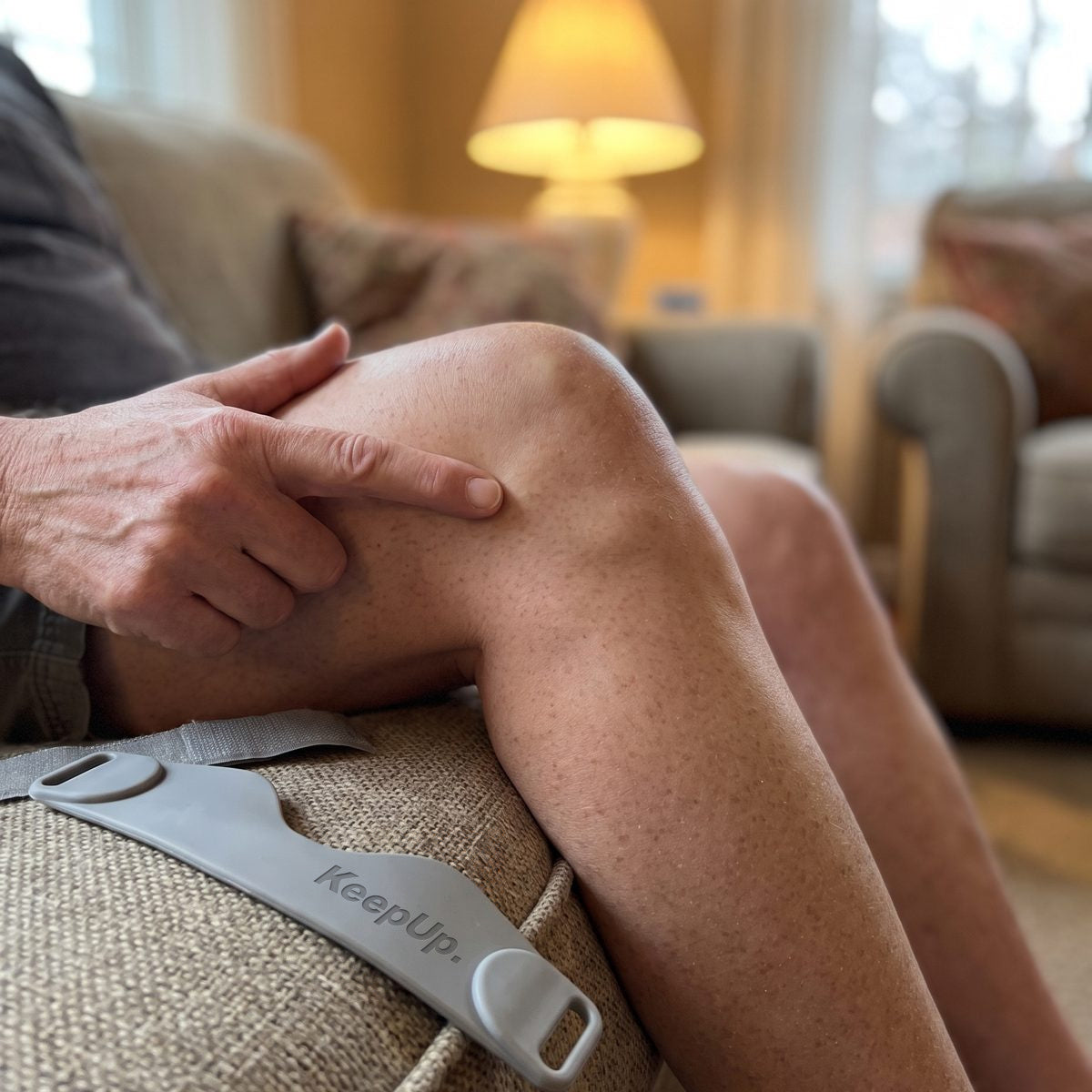 A finger pressing the soft spot just under the kneecap
